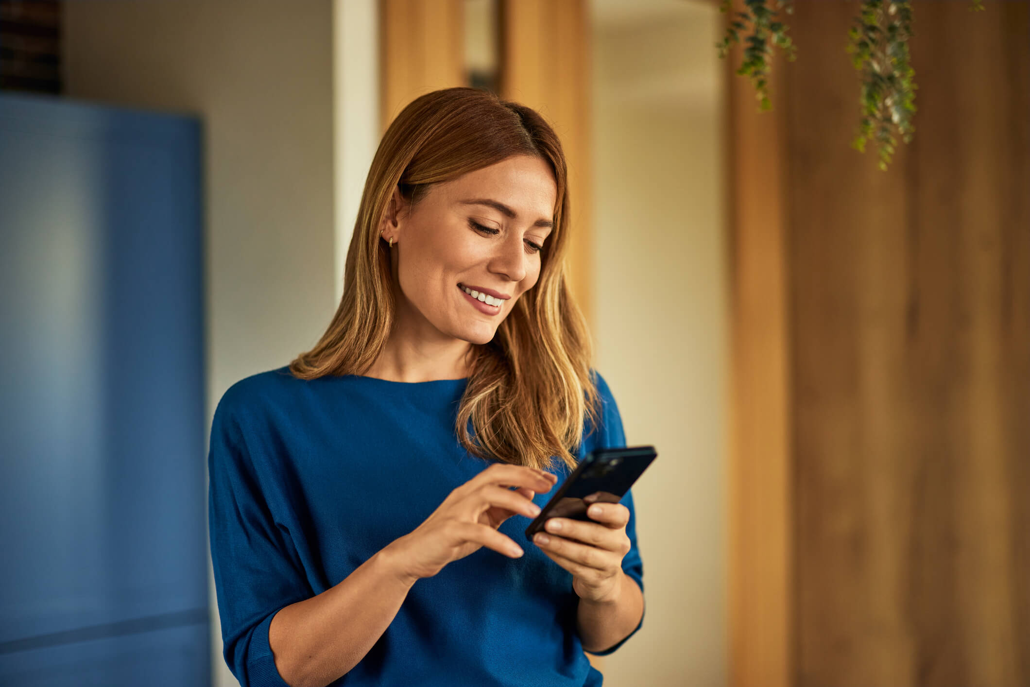 Woman looking at phone smiling